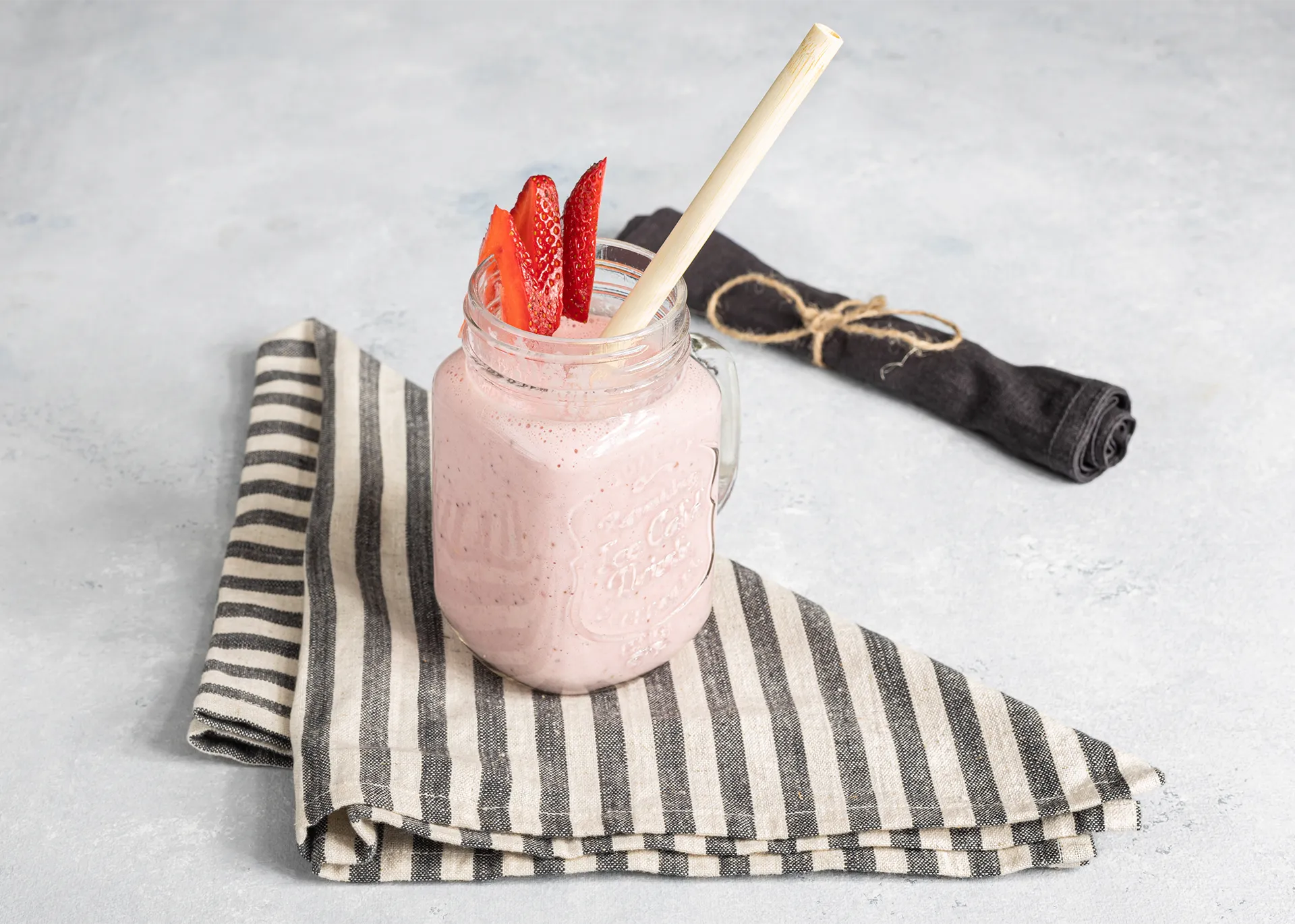 Batido de proteina de frutilla en jarra de vidrio